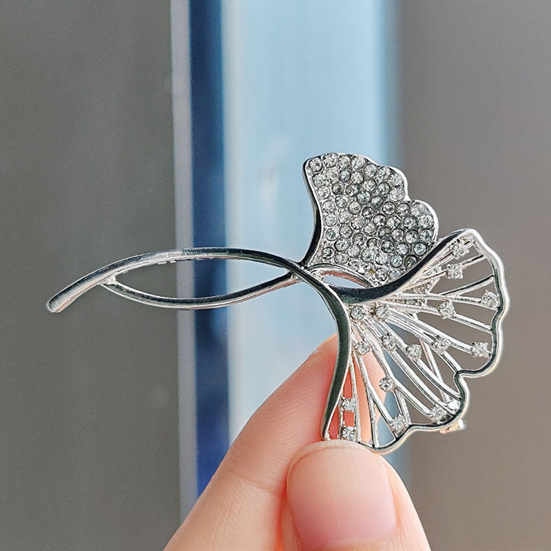 Elegant Ginkgo Leaf Brooch with crystals on a black jacket