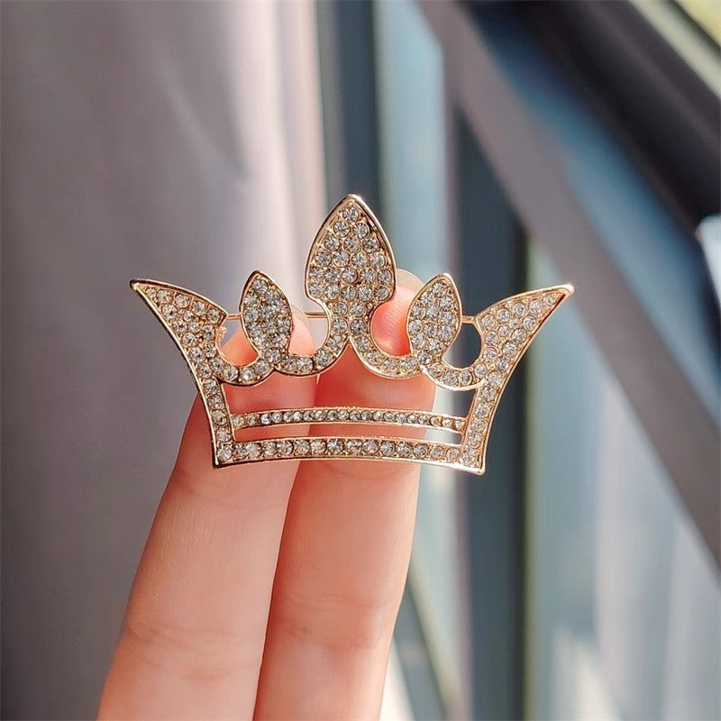 Gold crown brooch with rhinestones