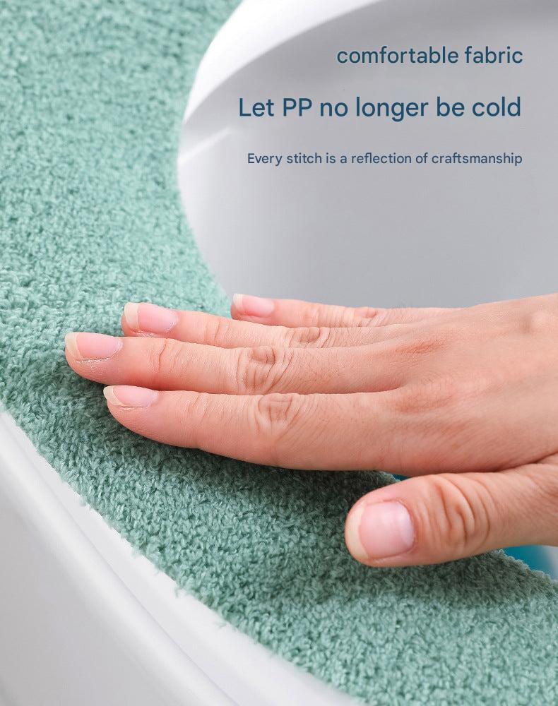 Adhesive backing feature of toilet seat cover