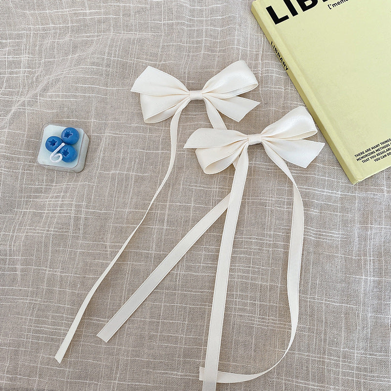 Blue bow hair clip styled on child's hair