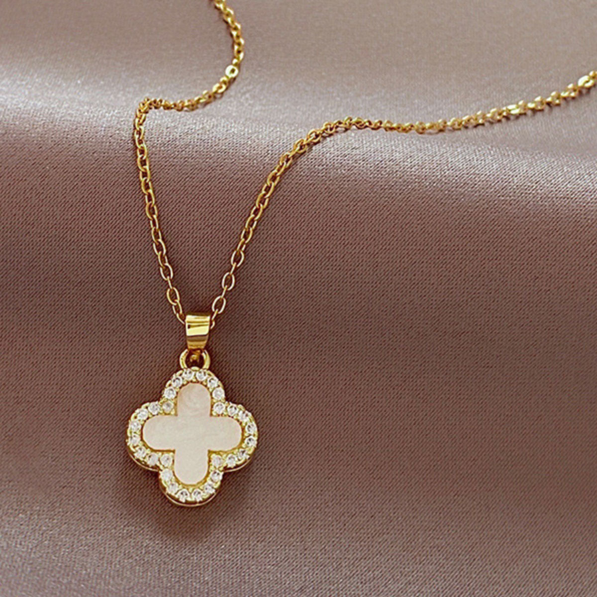 Image of a four-leaf clover necklace in gold