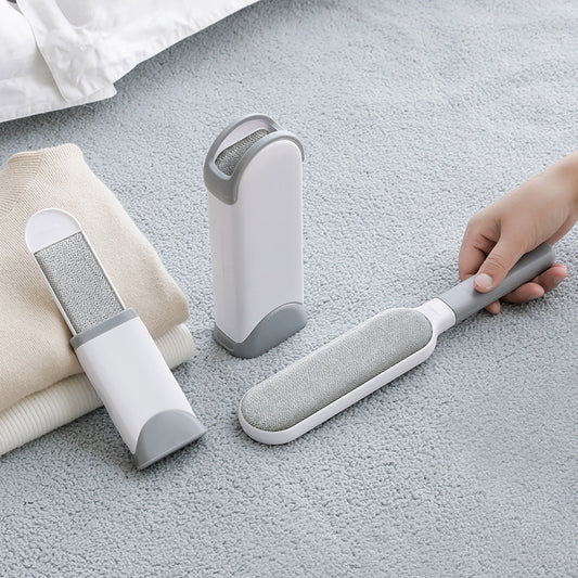 Double-sided pet hair remover brush displayed with pet hair