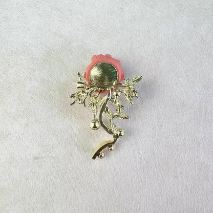 Detailed view of floral brooch with pearls on a dark background