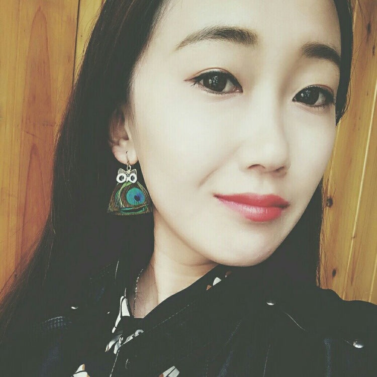 Vintage owl feather earrings close-up