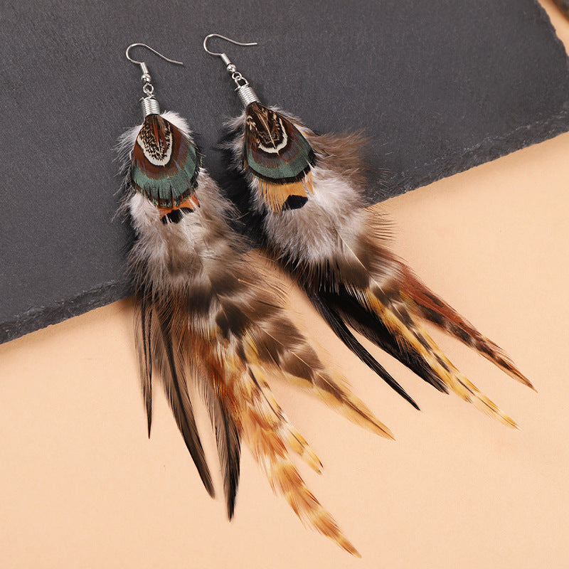 Long feather earrings in peacock blue