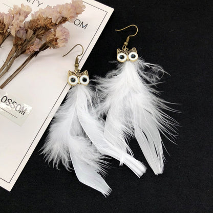 Vintage owl feather earrings close-up