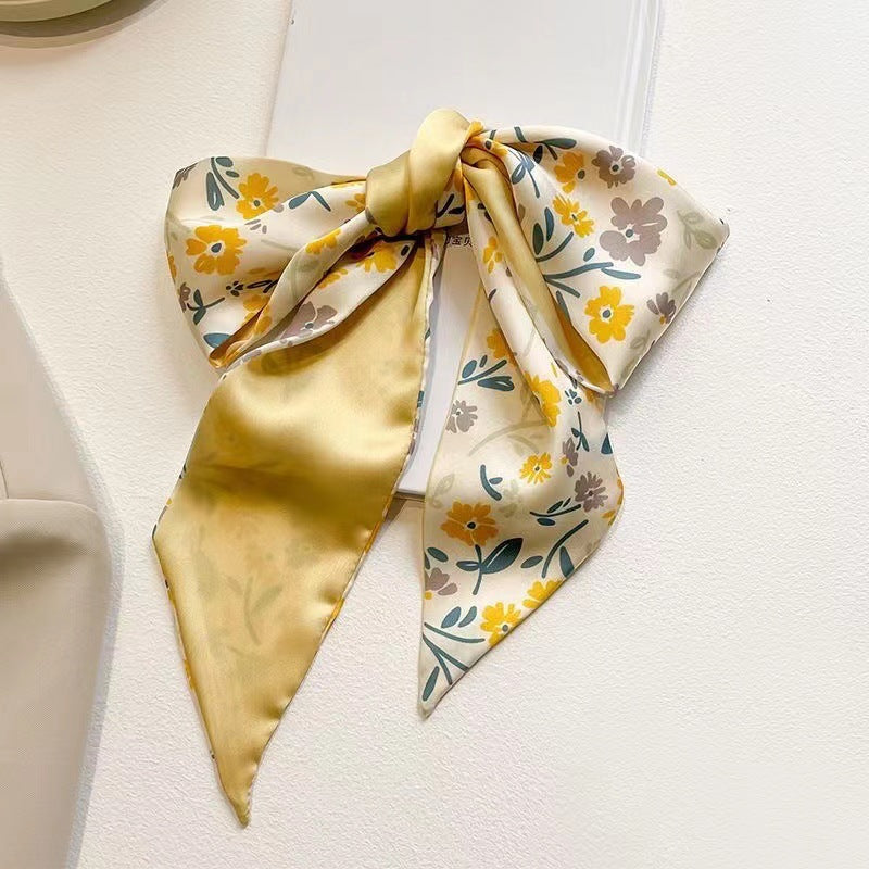 Yellow floral scarf draped on a model