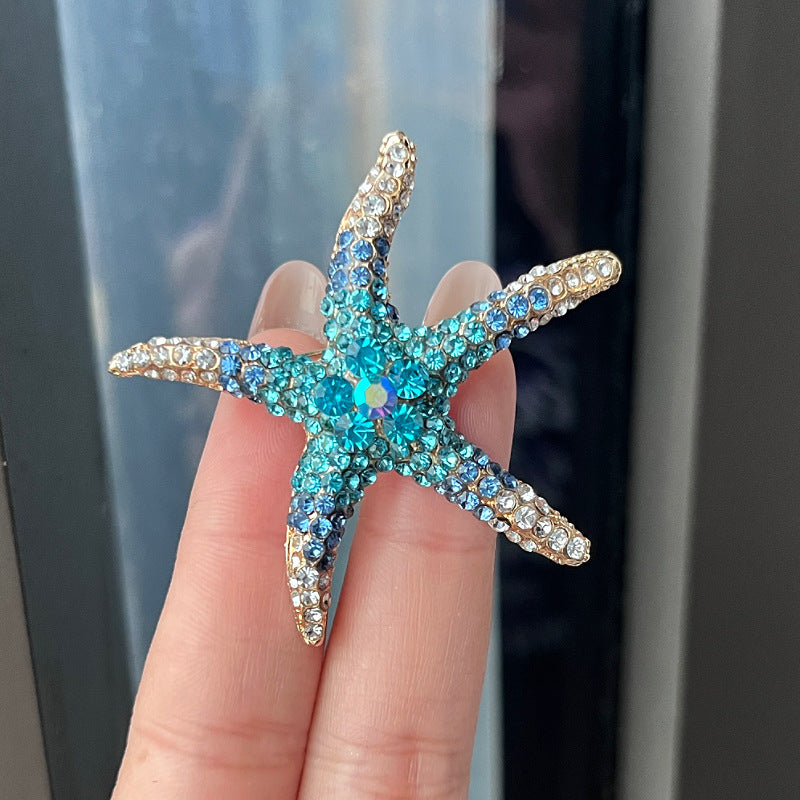 Rhinestone starfish brooch in blue