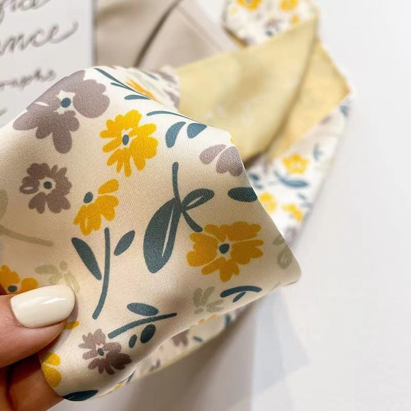 Yellow floral scarf draped on a model