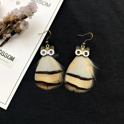 Vintage owl feather earrings close-up