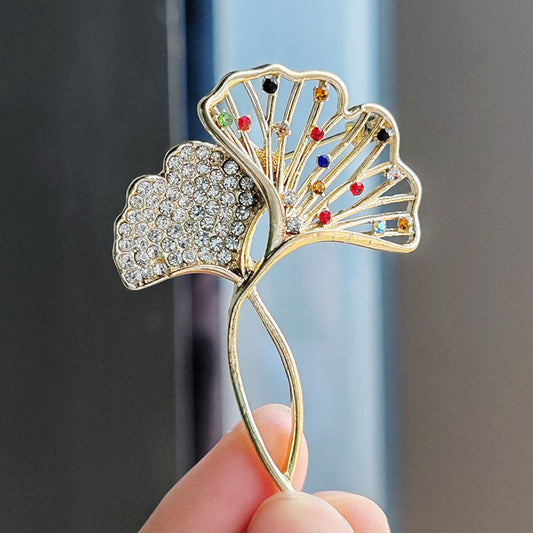 Elegant Ginkgo Leaf Brooch with crystals on a black jacket