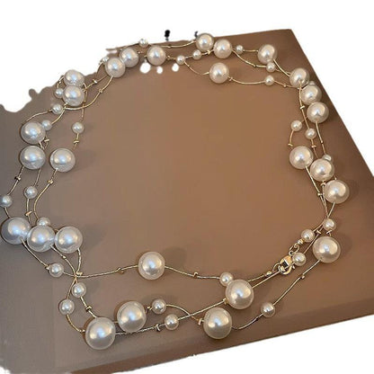 Long pearl necklace styled with a sweater