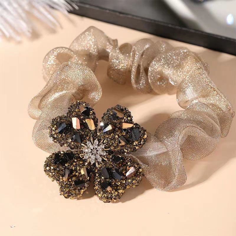 Chic fabric hair tie in clover pattern - gold color
