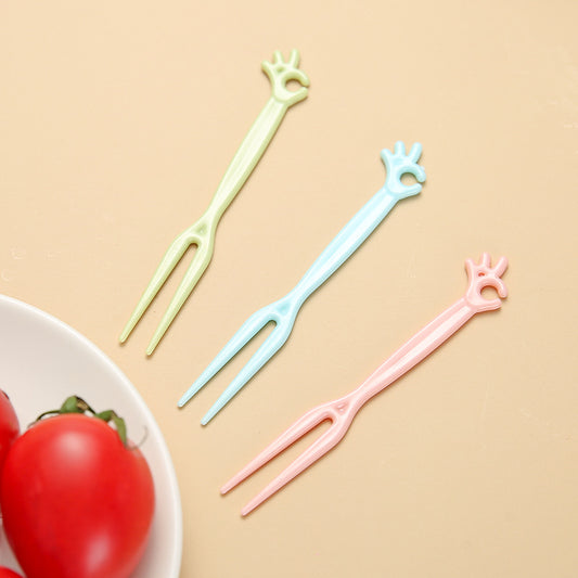 colorful disposable forks on a table with fruits
