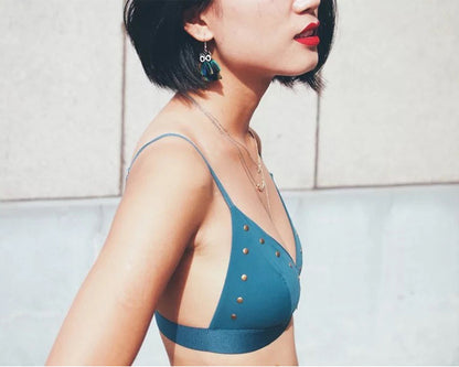 Peacock feather earrings displayed on a model