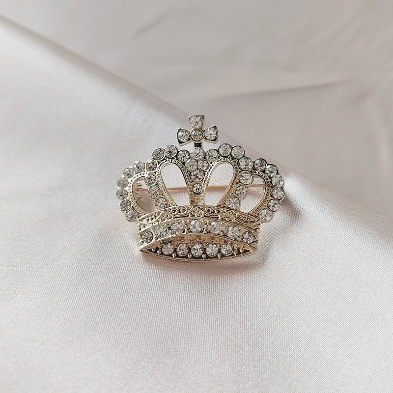 Gold crown brooch with rhinestones