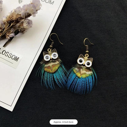 Vintage owl feather earrings close-up