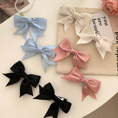 Blue bow hair clip styled on child's hair