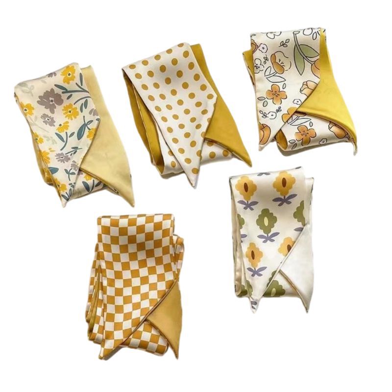Yellow floral scarf draped on a model