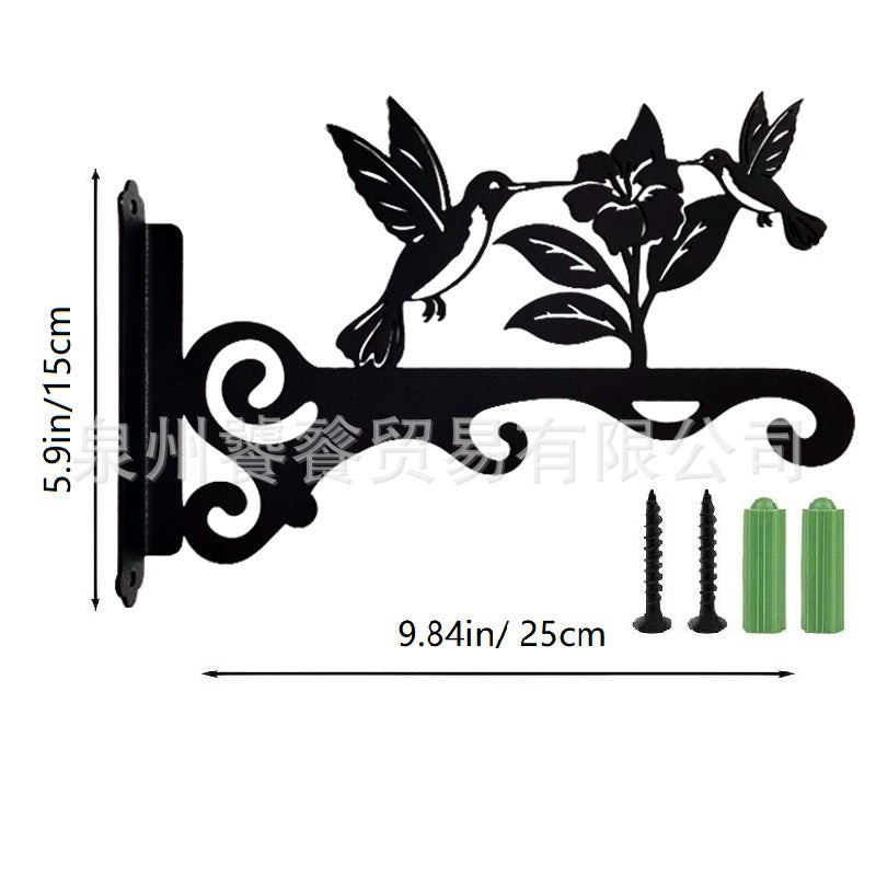 Iron flower basket mounted on a wall with plants