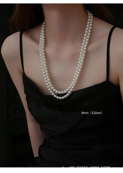 Elegant long pearl necklace on display